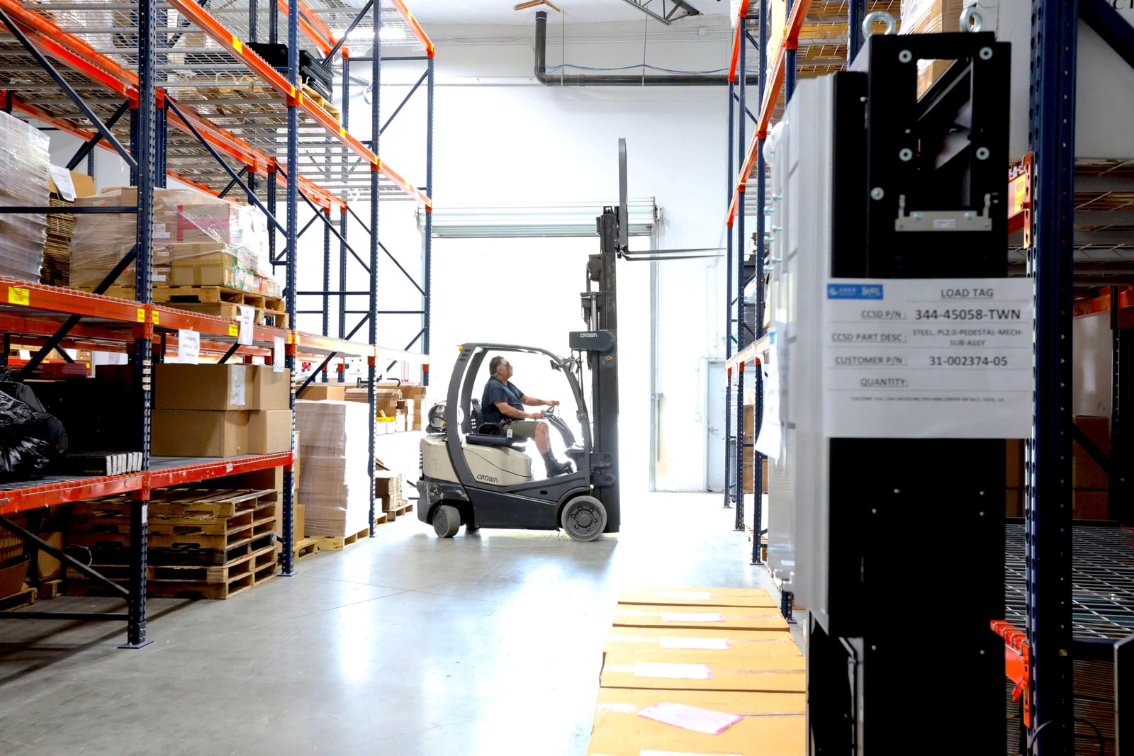 Forklift operator between storage racks in the Carlsbad warehouse
